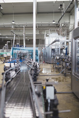 Industrial interiors. Robotic factory line for processing and quality control of pure spring water bottled into canisters.