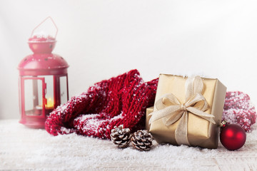 Christmas presents or gifts with elegant bow and christmas decorations on bright snowy background,...