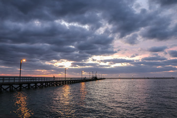 Fototapeta na wymiar Fishing Pier At Sunrise