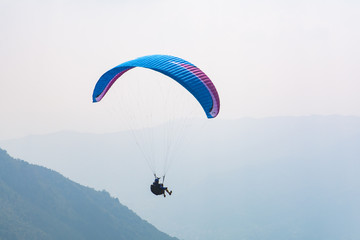 Paraglider flight over the mountains - 125954168