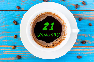 January 21st. Day 21 of month, Calendar on cup morning coffee or tea, teacher table background....