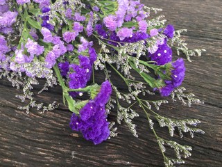 Purple flower bouquet on wood background
