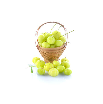 wooden bucket of fresh star gooseberry on white background