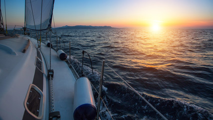 Sailing boat in the sea during a beautiful sunset.