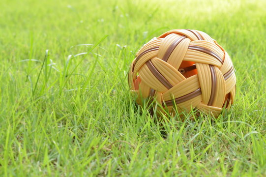 Rattan ball on green grass,sport equipment.