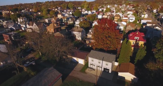 A rising aerial shot of a typical Western Pennsylvania neighborhood in the Autumn. Pittsburgh suburb.  	