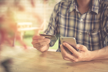 Hands holding credit card and using smart phone. Online shopping