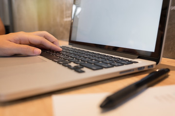 close up hand of business man and laptop and write on notebook o