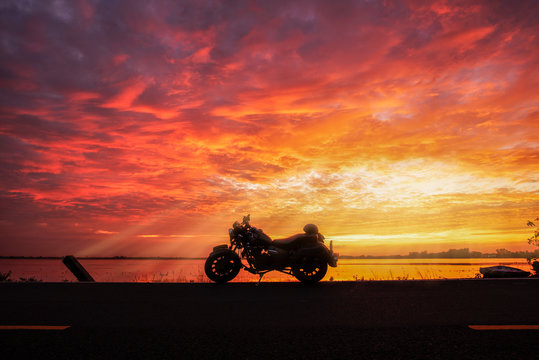 A silhouette big bike in sunset .