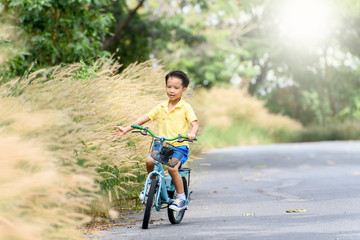 Fototapeta na wymiar Boy riding bicycle on the road.
