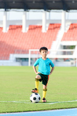 Obraz premium Boy and football in the football grass field