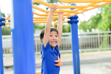 Fototapeta premium Young boy play with yellow bar