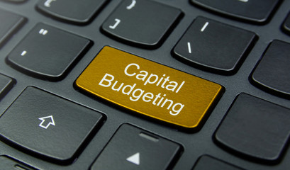 Business Concept: Close-up the Capital Budgeting button on the keyboard and have Gold, Yellow color button isolate black keyboard