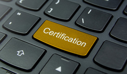 Business Concept: Close-up the Certification button on the keyboard and have Gold, Yellow color button isolate black keyboard