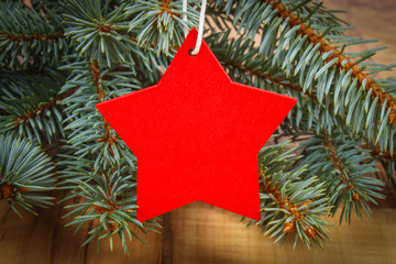 Spruce branches and red wooden star with copy space for text