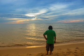 male turned to looking sunrise morning beautiful colorful water sea at light reflex