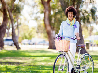Fototapeta na wymiar Happy young woman with bicycle