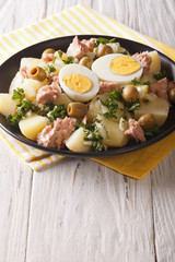 Spanish cuisine: Patatas Alinadas - Potatoes with Dressing closeup. Vertical