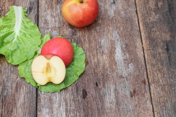 red apple ripe and Vegetable on the table wood 