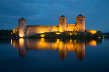 View of towers of Olavinlinn fortress in August night. Savonlinna, Finland