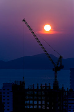 buildings under construction at sunset background