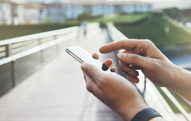 Hipster texting message on smartphone or technology, mockup of blank screen. Tourist using...