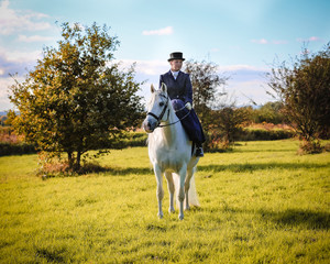 Girl and white horse with autumn landscape