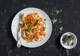 Pumpkin noodles spaghetti. Tasty vegetarian food. On a dark background, top view