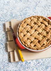 Rustic apple tart on a light background. Top view