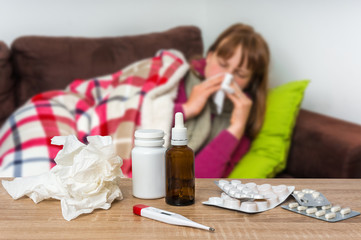 Obraz na płótnie Canvas Sick woman having flu and blowing her runny nose