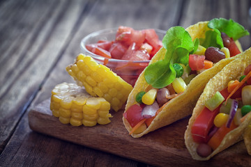 Mexican corn tortilla tacos with vegetables on wooden background  © circleps