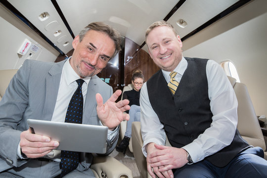 business team traveling in corporate jet