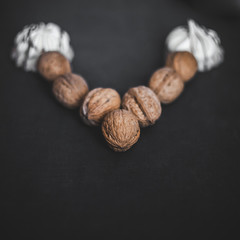 Many walnuts on a black background. Place for text. Autumn.