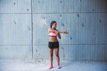 Fit woman runner stretching outdoors