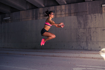 Fit woman runner warming up outdoors