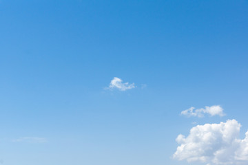 the white clouds floating on a background of blue sky