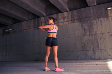 Fit woman runner stretching outdoors