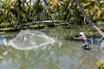 Traditional Fisherman throwing net