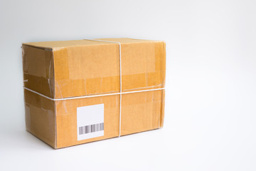cardboard box taped up with barcode on a white background.
