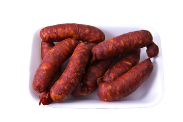 Tray of sausages isolated on white