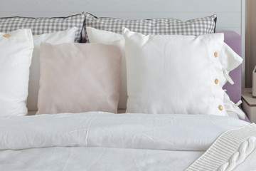 Off white pillows setting on English country style bedding in bedroom