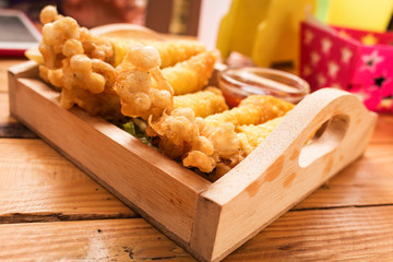 Golden needle mushroom with wonton fried on wooden dish