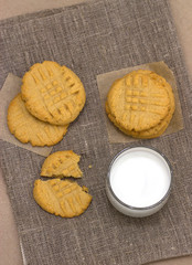 Healthy peanut butter cookies with milk on a linen napkin