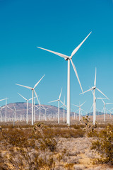 Wind turbines on a windfarm in California USA.  Vertical landscape with a wind turbines.