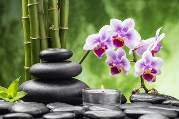 Fototapeta na wymiar spa still life with zen basalt stones ,orchid and bamboo with candle
