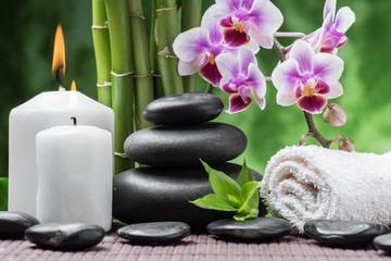 Obraz na płótnie Canvas spa still life with zen basalt stones ,orchid and bamboo with candle