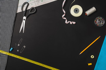 Background with sewing and knitting tools on black chalkboard