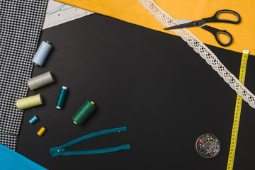 Background with sewing and knitting tools on black chalkboard