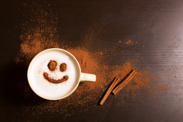 Cup of coffee with smile pattern of cinnamon