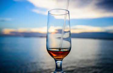 a glass of wine on the background of the sea s